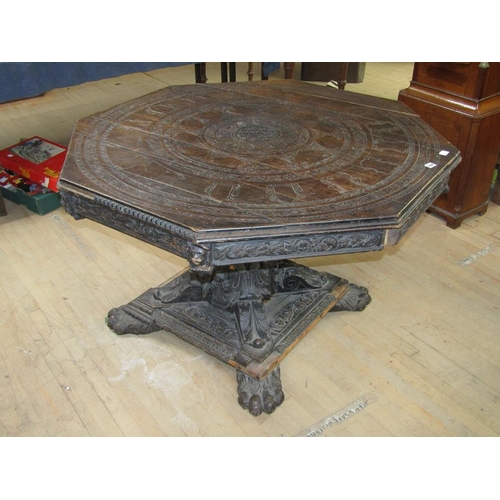 1664 - EARLY 19C OAK CENTRE TABLE OF OCTAGONAL FORM ON BOLD CARVED COLUMN, A/F 119CM W, 76CM H