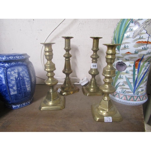 59 - TWO PAIRS OF ANTIQUE BRASS CANDLESTICKS