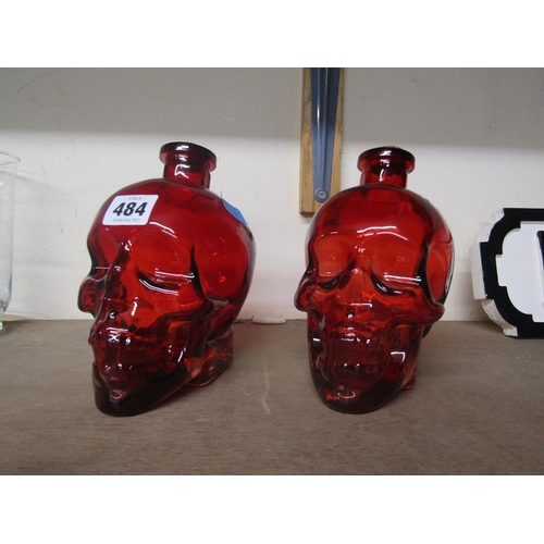 484 - PAIR OF RED GLASS SKULL DECANTERS