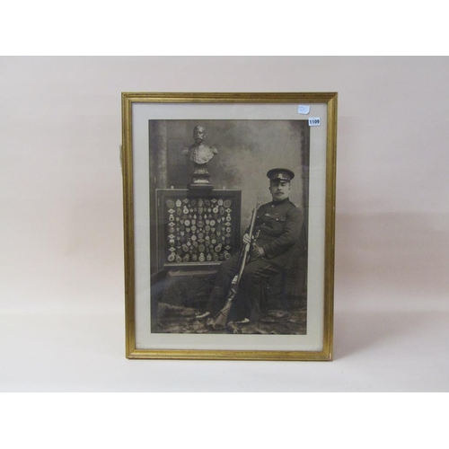 1109 - EARLY 20C B&W PHOTOGRAPH - ARMY MARKSMAN WITH HIS TROPHIES, F/G, 82CM X 44CM