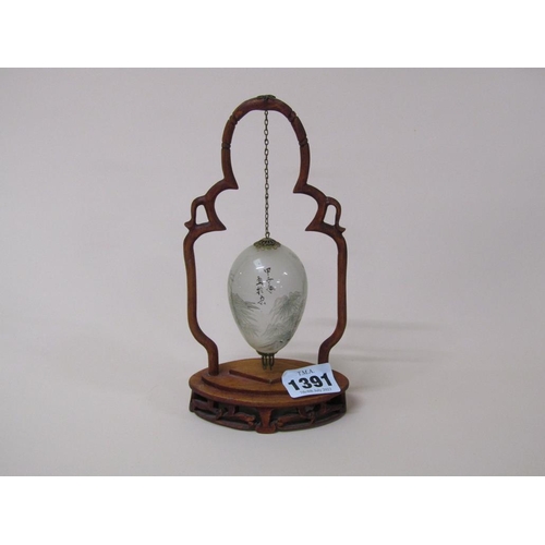 1391 - JAPANESE EGG SHAPED SUSPENDED GLASS SPHERE IN A WOODEN FRAME 19cms H