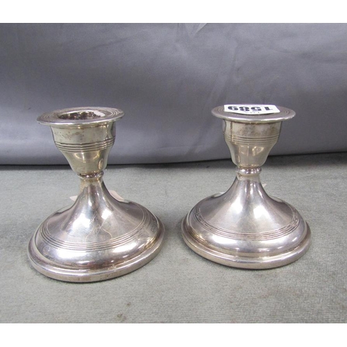 1589 - PAIR OF SILVER SHORT FILLED CANDLESTICKS, EACH 8.5cms H