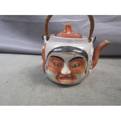 1717 - JAPANESE TEAPOT RELIEF MOULDED WITH FACES, 14CM H