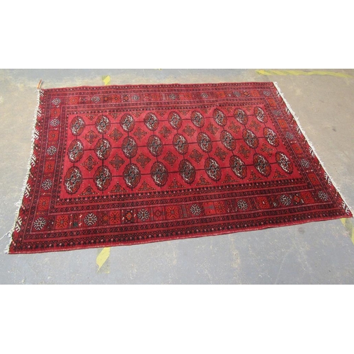 1877 - RED GROUND ORIENTAL WOOLLEN RUG 133 x 203 cms