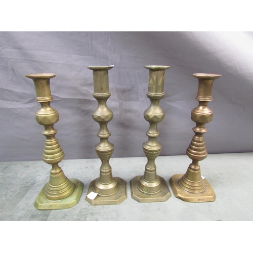 1344 - FOUR BRASS CANDLESTICKS