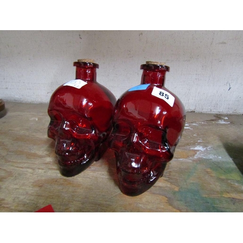 85 - PAIR OF RED GLASS SKULL DECANTERS