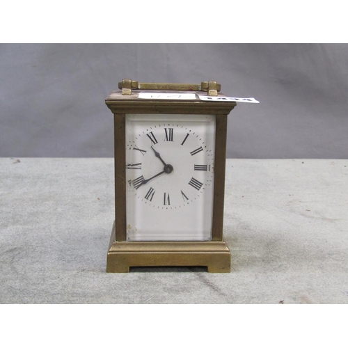 1434 - BRASS CASED CARRIAGE CLOCK - 12 cms H WITH THE HANDLE RAISED