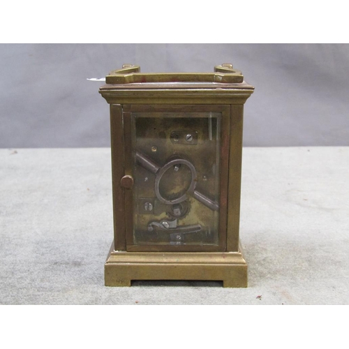 1434 - BRASS CASED CARRIAGE CLOCK - 12 cms H WITH THE HANDLE RAISED