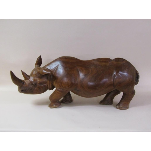 55 - A carved trunk wood rhinoceros, 113cm l, 48cm h.