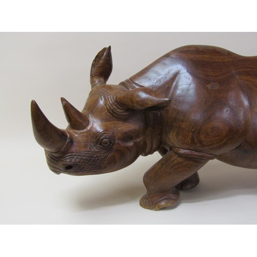 55 - A carved trunk wood rhinoceros, 113cm l, 48cm h.
