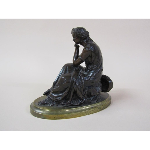 33 - A 19c patinated bronze figure of a seated classical lady, robed and accompanied by a lyre, on an ova... 