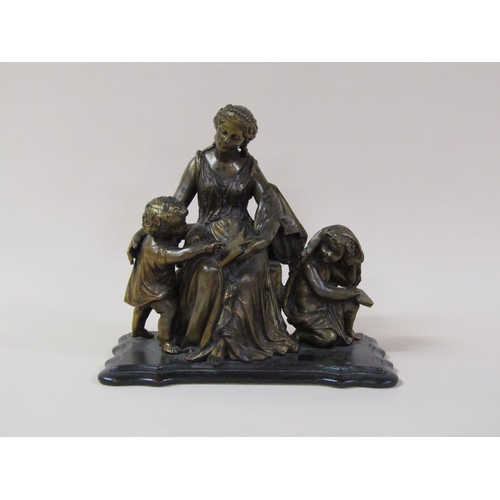 35 - A 19c gilt metal figure group of a lady seated, robed and accompanied by two children reading books,... 
