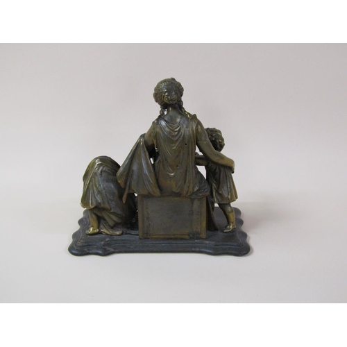 35 - A 19c gilt metal figure group of a lady seated, robed and accompanied by two children reading books,... 