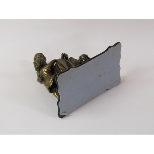 35 - A 19c gilt metal figure group of a lady seated, robed and accompanied by two children reading books,... 