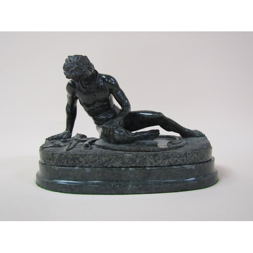 39 - A 19c serpentine sculpture of defeated warrior on an oval base, 32cm w, 21cm h.