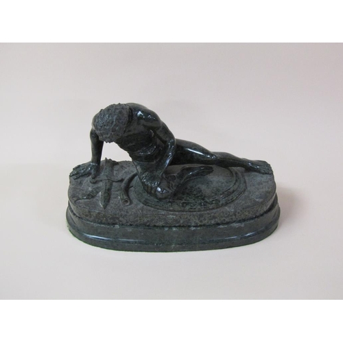 39 - A 19c serpentine sculpture of defeated warrior on an oval base, 32cm w, 21cm h.