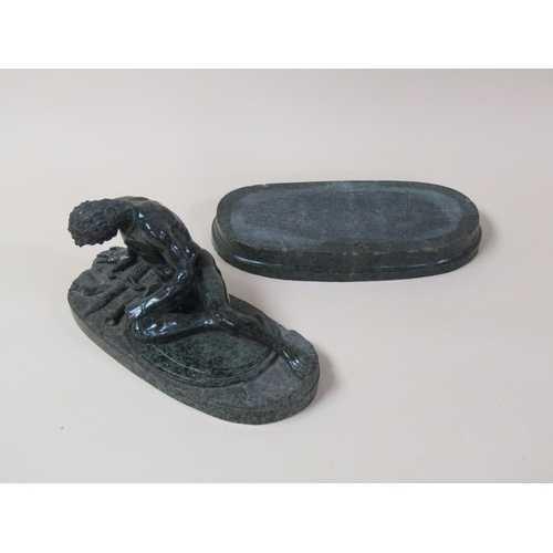 39 - A 19c serpentine sculpture of defeated warrior on an oval base, 32cm w, 21cm h.