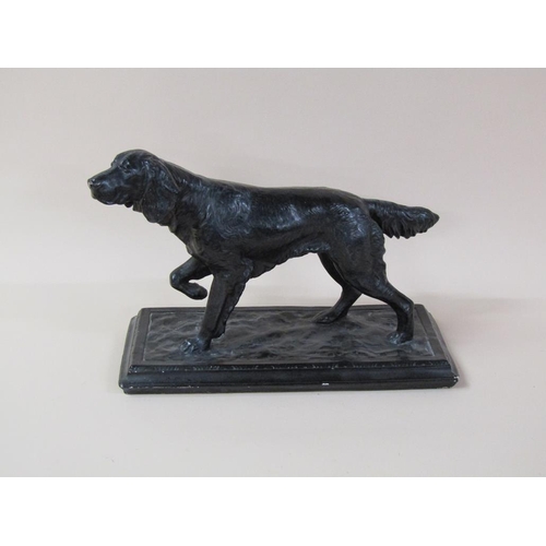 40 - A black painted figure of a dog on base, dog 41cm l, 25cm h.