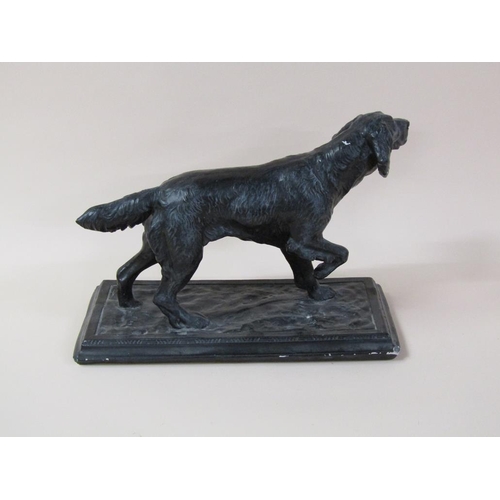 40 - A black painted figure of a dog on base, dog 41cm l, 25cm h.