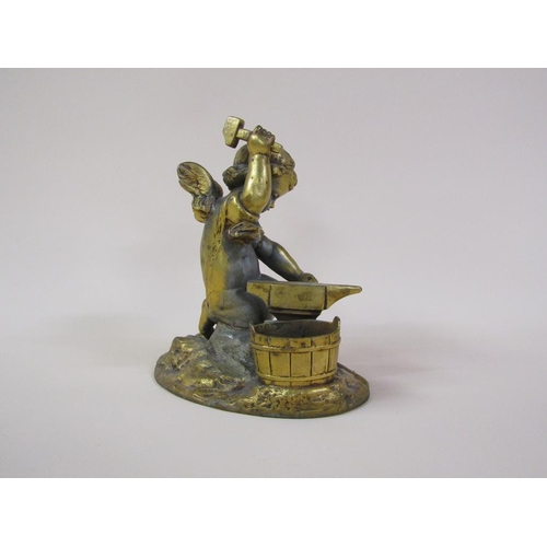 41 - A late 19c gilt metal figure group of a Blacksmith cherub, 16cm h.