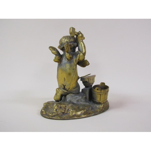 41 - A late 19c gilt metal figure group of a Blacksmith cherub, 16cm h.
