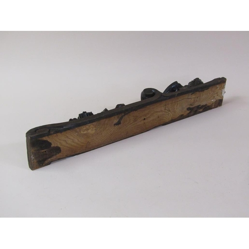 57 - A pair of 19c oak furniture mounts carved with lion and shield, over suspended bow and flowers, each... 