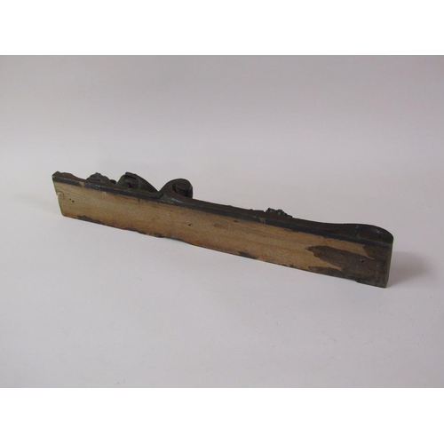 57 - A pair of 19c oak furniture mounts carved with lion and shield, over suspended bow and flowers, each... 