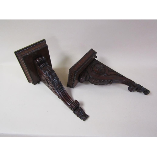 58 - A pair of 19c mahogany wall brackets, the platform with carved edge supported on carved scroll and l... 