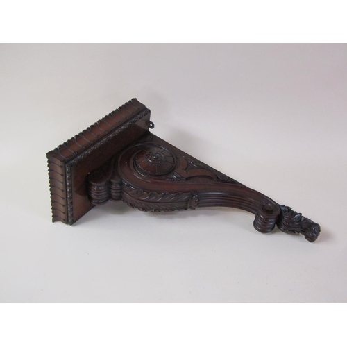 58 - A pair of 19c mahogany wall brackets, the platform with carved edge supported on carved scroll and l... 