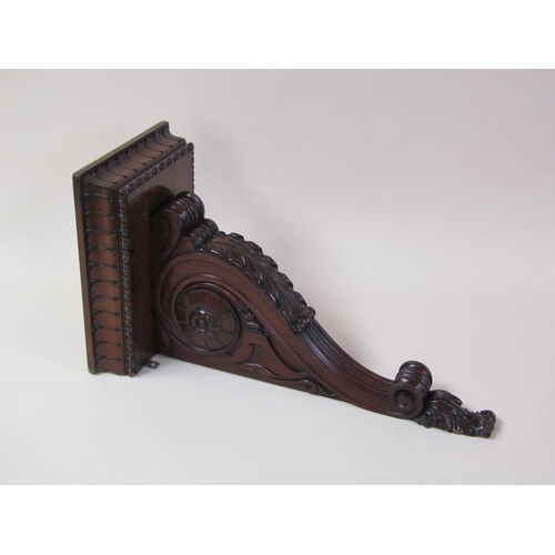 58 - A pair of 19c mahogany wall brackets, the platform with carved edge supported on carved scroll and l... 