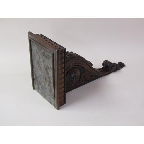 58 - A pair of 19c mahogany wall brackets, the platform with carved edge supported on carved scroll and l... 