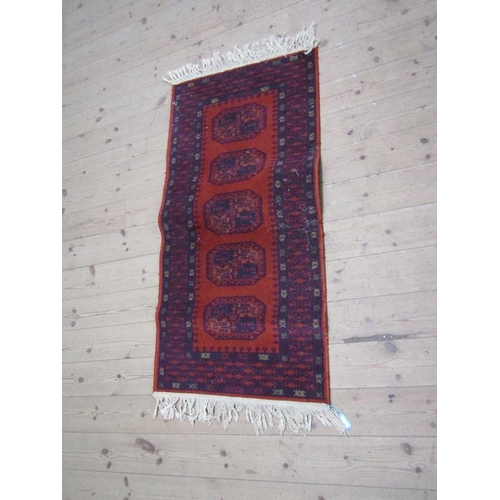 1756A - RED GROUND ORIENTAL STYLE WOOLLEN RUG - 67 x 135 cms