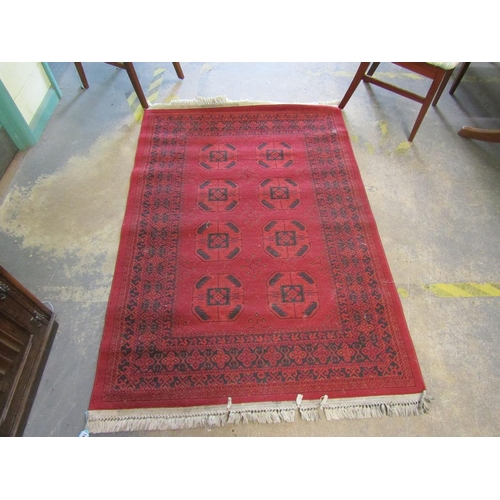 1920 - AFGHAN RED GROUND WOOLLEN RUG 121 X 183 cms