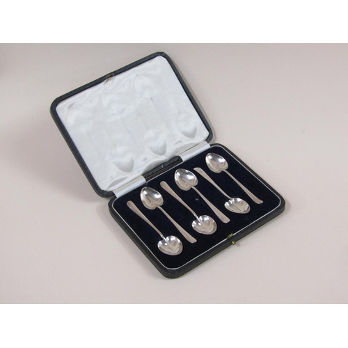 1754 - BOXED SET OF SIX HEART BOWLED SILVER SPOONS AND A SILVER BOTTLE LABEL