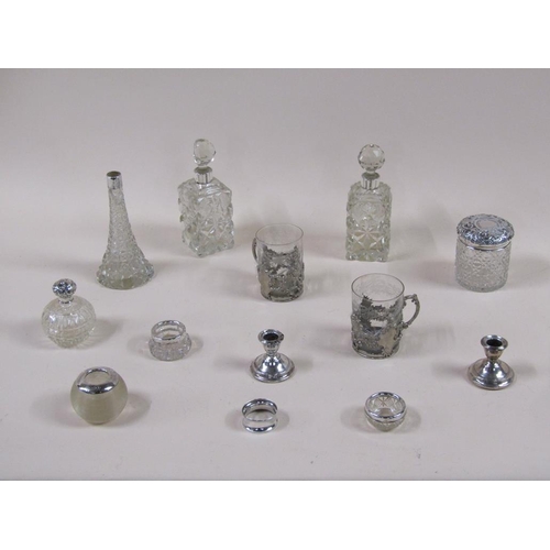 1767 - BOX OF CUT GLASS BOTTLES, JARS, BEAKERS ETC. WITH SILVER TOPS AND TWO SILVER NAPKIN RINGS ETC