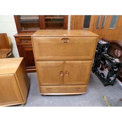 1979 - ERCOL SECRETAIRE CABINET WITH FALL FRONT OVER CUPBOARD AND ONE LONG BASE DRAWER 82 x 110cms