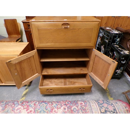 1979 - ERCOL SECRETAIRE CABINET WITH FALL FRONT OVER CUPBOARD AND ONE LONG BASE DRAWER 82 x 110cms