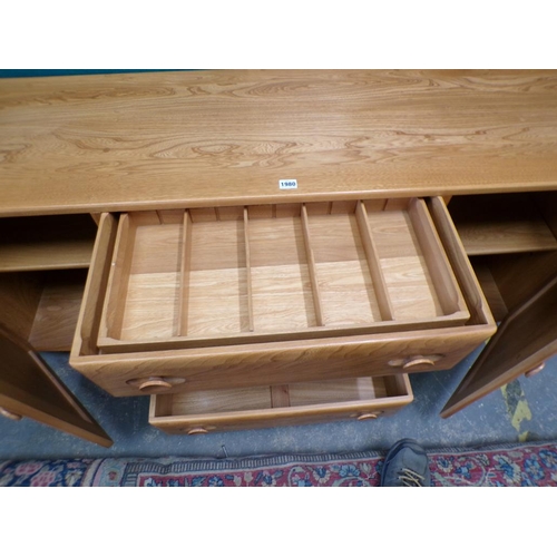 1980 - ERCOL TEAK SIDEBOARD OF THREE CENTRAL DRAWERS FLANKED BY TWO CUPBOARDS ENCLOSED BY SINGLE DOORS 156 ... 