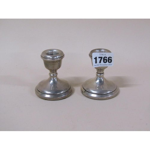 1766 - PAIR OF SQUAT SILVER CASED CANDLESTICKS