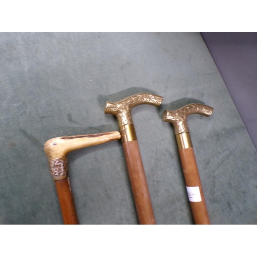 1439 - THREE WALKING STICKS - TWO BRASS AND ONE HORN HANDLED