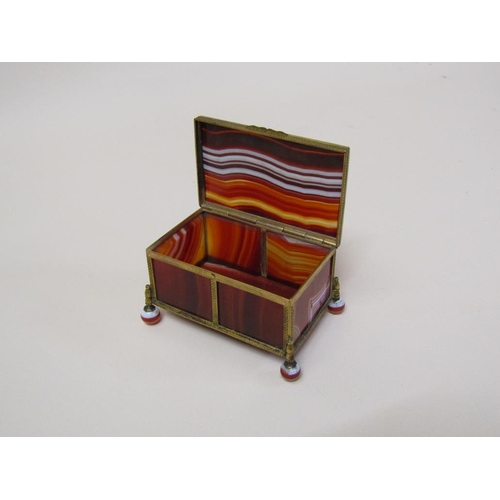 103 - An early 20c banded agate and brass framed box on agate ball feet, together with a vesta case of sim... 