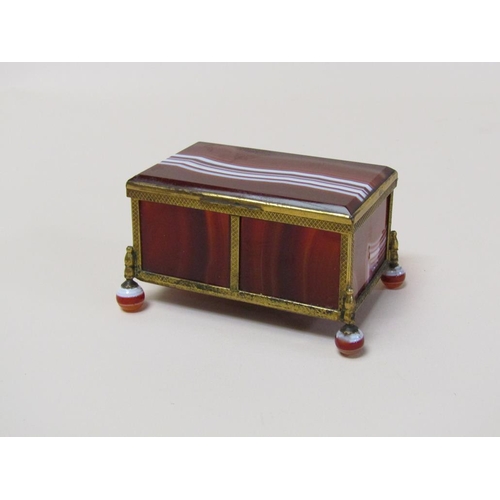 103 - An early 20c banded agate and brass framed box on agate ball feet, together with a vesta case of sim... 