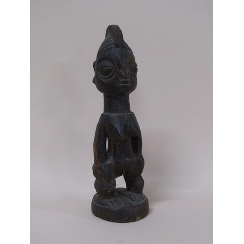 49 - A Nigerian Yoruba carved wooden memora figure - Ereibeji, with a shell costume, 33cm h.