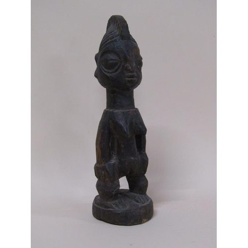 49 - A Nigerian Yoruba carved wooden memora figure - Ereibeji, with a shell costume, 33cm h.