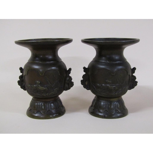 57 - A pair of 19c Oriental bronze baluster vases, the bodies decorated with lakeside scenes and having w... 