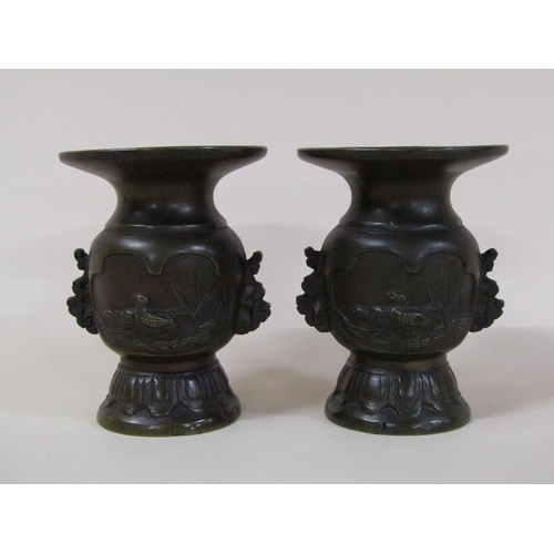 57 - A pair of 19c Oriental bronze baluster vases, the bodies decorated with lakeside scenes and having w... 