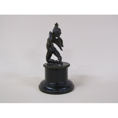 61 - A Tom Merrifield bronze figure of a cherub on circular beaded base and marble stand, the figure 12cm... 