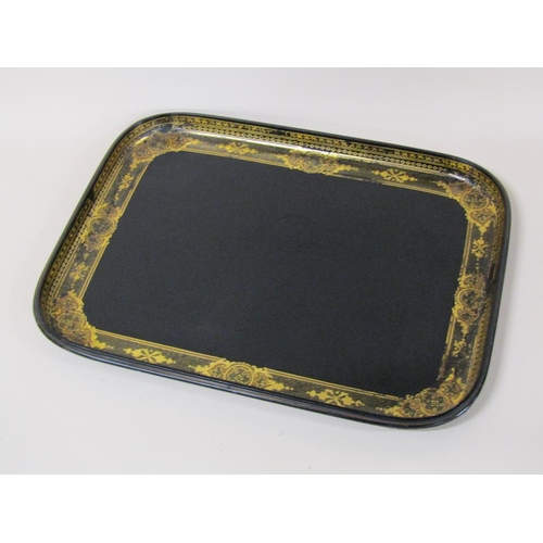 67 - A black lacquered papier mache tea tray of rectangular form with a raised border, gilt decorated, 62... 