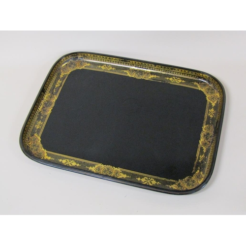 67 - A black lacquered papier mache tea tray of rectangular form with a raised border, gilt decorated, 62... 