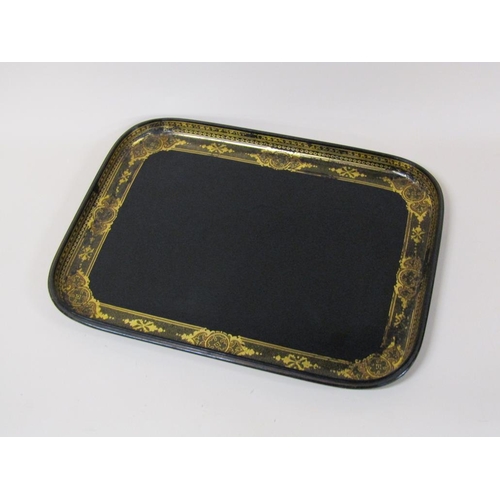 67 - A black lacquered papier mache tea tray of rectangular form with a raised border, gilt decorated, 62... 